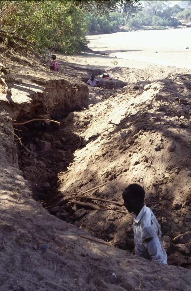 Man digging a ditch.