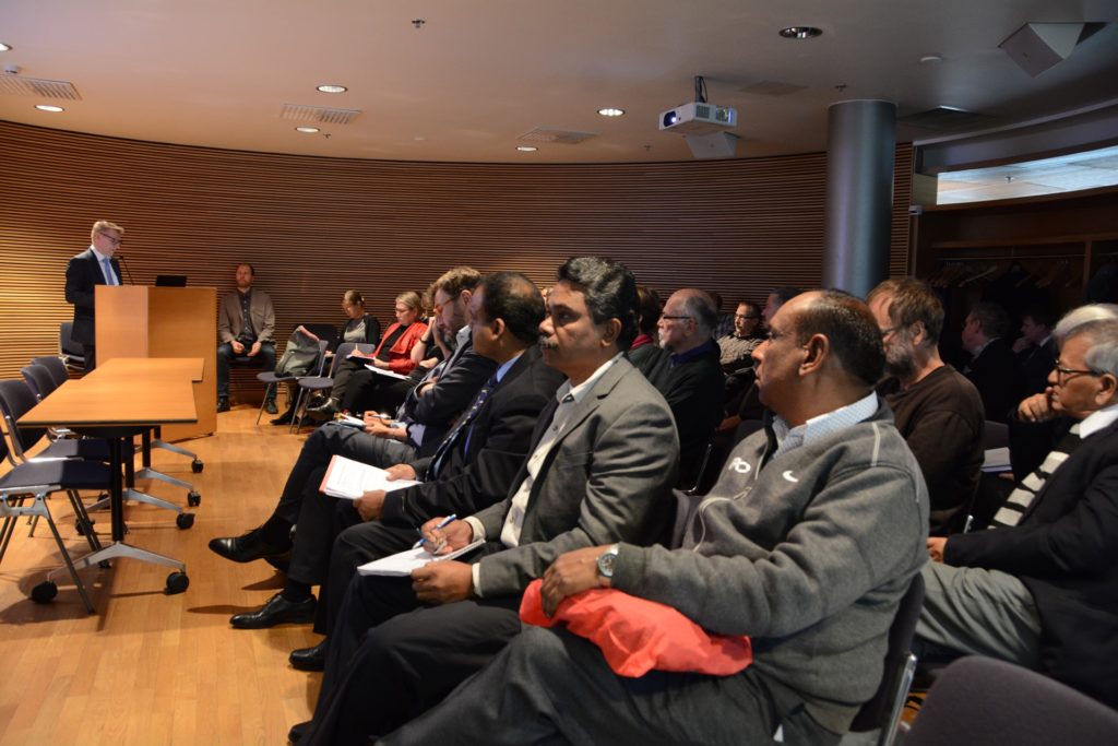 Audience sitting and listening man speaking in a meeting hall.