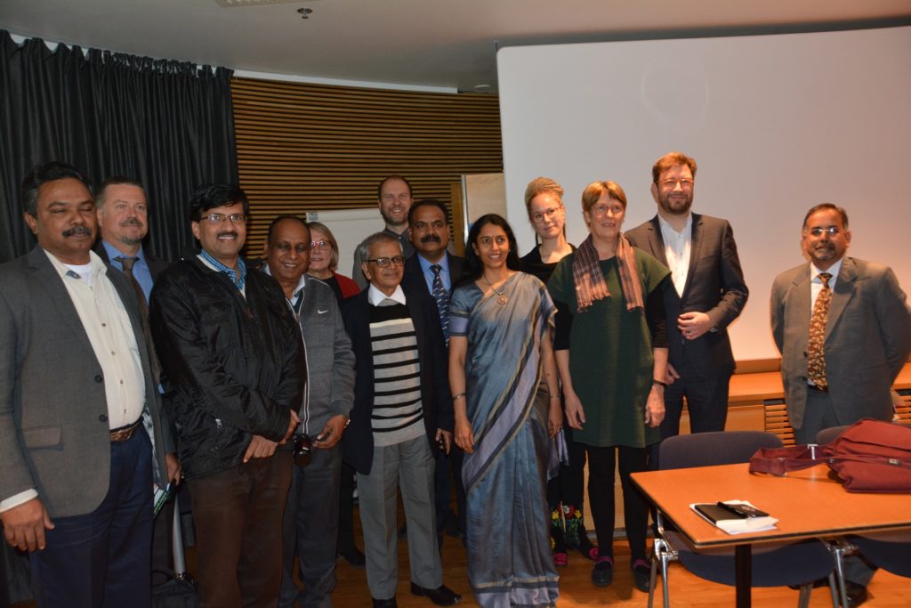 Group photo of some 15 people in a meeting room.