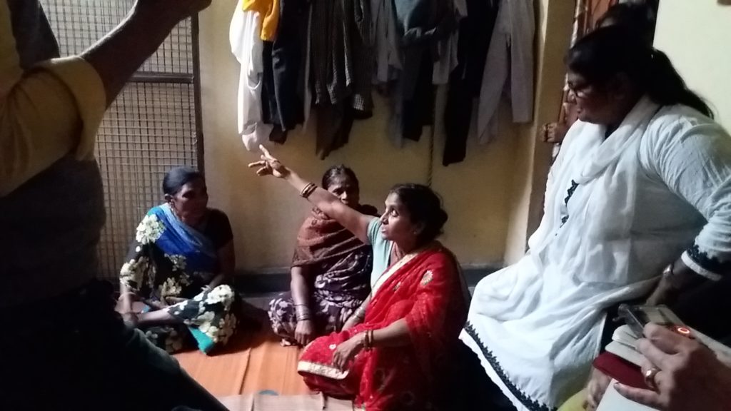 Four woman in Indian dresses discussing.